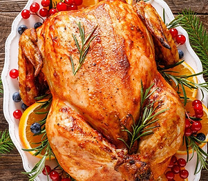 Platter of succulent roasted holiday turkey served with festive side dishes and seasonal garnishes for a catered Christmas di